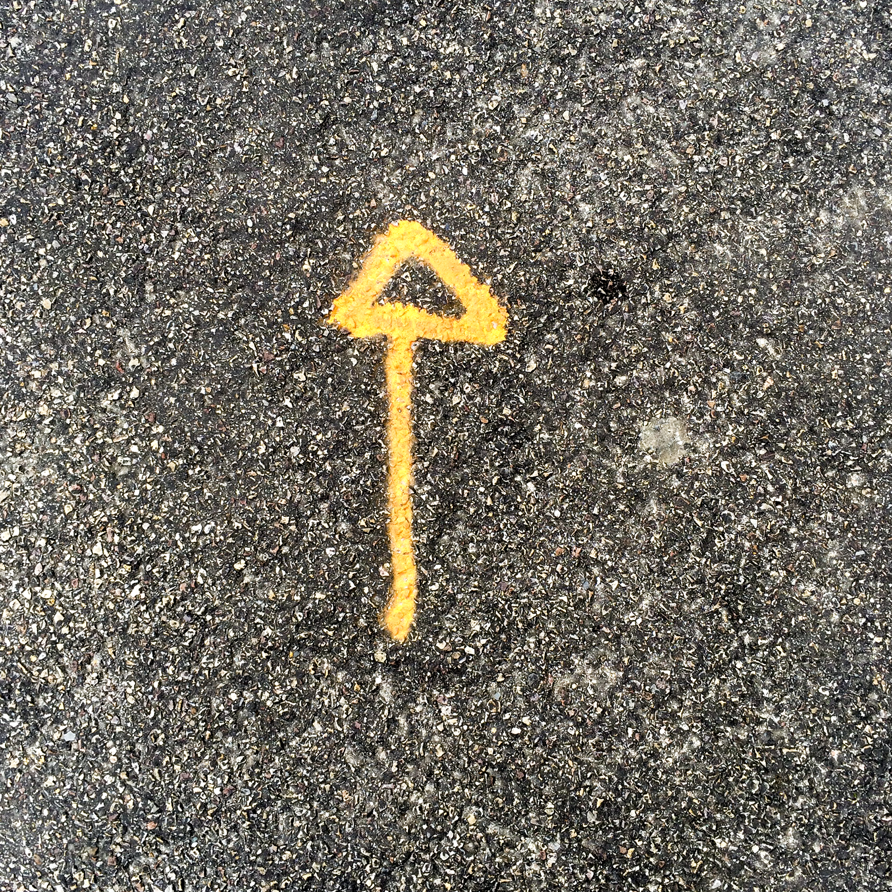 4th of 6 placeholder images: yellow arrow spraypainted on pavement